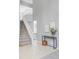 Bright and spacious entryway with staircase and decoratively styled console table at 7700 Bison Ct, Littleton, CO 80125