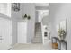 Grand entryway featuring a soaring staircase, tiled floor, and stylish decor at 7700 Bison Ct, Littleton, CO 80125
