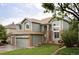 Charming two-story home with well-maintained lawn, brick accents, and a three-car garage at 7700 Bison Ct, Littleton, CO 80125