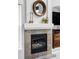 Close-up of a fireplace with stone surround and decorative mantel at 7700 Bison Ct, Littleton, CO 80125