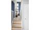 Hallway featuring tile floors and a view into a brightly lit living space at 7700 Bison Ct, Littleton, CO 80125