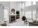 Bright living room with a cozy fireplace, large windows, and neutral-toned furnishings at 7700 Bison Ct, Littleton, CO 80125