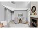 Inviting living room featuring high ceilings, neutral decor, and a cozy fireplace at 7700 Bison Ct, Littleton, CO 80125
