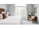 Inviting bedroom featuring a large window and a cozy reading chair at 7700 Bison Ct, Littleton, CO 80125
