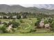 Panoramic view of homes nestled in a neighborhood setting with rolling hills and walking trails at 7700 Bison Ct, Littleton, CO 80125