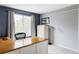 Home office featuring a large desk, natural light, and modern furnishings at 7700 Bison Ct, Littleton, CO 80125