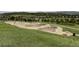 Community skate park features smooth concrete bowls, ramps, and green grassy surroundings at 7700 Bison Ct, Littleton, CO 80125