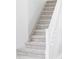 Carpeted staircase with white railing at 7700 Bison Ct, Littleton, CO 80125