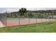 Outdoor tennis court with a view of the mountains and surrounding greenery at 7700 Bison Ct, Littleton, CO 80125