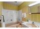 Retro bathroom design with a pink tub, toilet, and vanity, complemented by yellow wallpaper at 6960 S Penrose Ct, Centennial, CO 80122