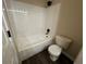 Bathroom features white tiled shower-tub and toilet at 12036 Monaco St, Brighton, CO 80602