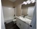 Bathroom features white tiled shower-tub and granite counter tops with black hardware at 12036 Monaco St, Brighton, CO 80602