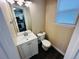 Bright half bathroom with a modern vanity and fixtures, next to the kitchen at 12036 Monaco St, Brighton, CO 80602