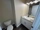A well-lit bathroom featuring granite countertops, modern lighting fixtures, and a sleek vanity at 12036 Monaco St, Brighton, CO 80602