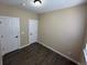 A light-filled bedroom featuring neutral-colored walls and dark wood-look floors at 12036 Monaco St, Brighton, CO 80602