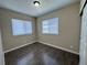 A bright and sunny bedroom with wood-look floors and a neutral color scheme at 12036 Monaco St, Brighton, CO 80602