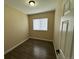 A cozy bedroom with neutral-colored walls and dark wood-look floors at 12036 Monaco St, Brighton, CO 80602