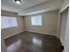 Bright bedroom featuring wood floors, neutral walls, and natural light at 12036 Monaco St, Brighton, CO 80602