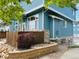 Charming home exterior with wood fence, rock landscaping, and blue siding at 12036 Monaco St, Brighton, CO 80602
