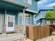 Charming exterior showcasing the blue siding, stone accents, and well-maintained front yard at 12036 Monaco St, Brighton, CO 80602