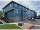 Exterior view of townhome community with attached garages and neat landscaping at 12036 Monaco St, Brighton, CO 80602