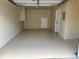 Clean, spacious two car garage with durable epoxy flooring and ample storage space at 12036 Monaco St, Brighton, CO 80602