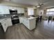 Modern kitchen featuring white cabinets, granite countertops, and stainless steel appliances at 12036 Monaco St, Brighton, CO 80602