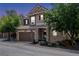 Two-story home with stone and siding exterior, two-car garage, and landscaping at 11926 Amston Pl, Parker, CO 80134