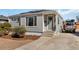 Inviting single-story home featuring light-grey siding, and a cozy entryway leading to the front door at 1040 Florence St, Aurora, CO 80010