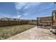 Private backyard featuring a cozy lounge area, well-maintained grass, and a secure wooden fence at 9466 Quintero St, Commerce City, CO 80022