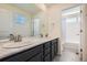 Bright bathroom with double sinks, a large mirror, modern fixtures, and an adjacent toilet and shower space at 9466 Quintero St, Commerce City, CO 80022