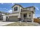 Charming two-story home with a three-car garage and a welcoming front porch at 9466 Quintero St, Commerce City, CO 80022