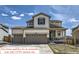 Charming two-story home featuring a two-car garage and inviting front porch under a bright blue sky at 9466 Quintero St, Commerce City, CO 80022