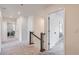 Upstairs hallway featuring neutral carpet, white walls, and access to rooms at 9466 Quintero St, Commerce City, CO 80022