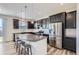 Kitchen with stainless appliances, granite countertops, and dark cabinets at 9466 Quintero St, Commerce City, CO 80022