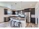 Modern kitchen features granite countertops, stainless steel appliances, island with seating at 9466 Quintero St, Commerce City, CO 80022