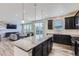 Kitchen with an island, stainless appliances, and opens up to the living room at 9466 Quintero St, Commerce City, CO 80022