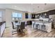 Eat-in kitchen with an island, stainless appliances, and a dining table at 9466 Quintero St, Commerce City, CO 80022