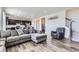 Comfortable living room with wood floors, plush seating, and an open floor plan at 9466 Quintero St, Commerce City, CO 80022