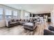 Open-concept living room flows to the kitchen and offers a large sectional sofa at 9466 Quintero St, Commerce City, CO 80022