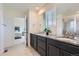 Main bathroom includes double sinks, granite countertops, and a glass-enclosed shower at 9466 Quintero St, Commerce City, CO 80022