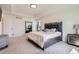 Well-lit main bedroom with a large bed, carpet flooring, and modern furnishings at 9466 Quintero St, Commerce City, CO 80022