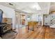 Finished basement with a stone fireplace, foosball table, sliding glass doors to the backyard, and wood flooring at 7904 Hill Crest Dr, Louviers, CO 80131