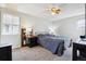 Comfortable bedroom features a ceiling fan, neutral walls and carpeted flooring, offering a cozy retreat at 7904 Hill Crest Dr, Louviers, CO 80131