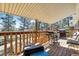 Spacious covered deck with wood railings, grill, and forest views for outdoor entertaining at 7904 Hill Crest Dr, Louviers, CO 80131