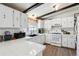 Bright kitchen with white cabinets, white tile countertops and modern appliances at 7904 Hill Crest Dr, Louviers, CO 80131