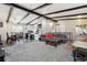 Open-concept living area featuring exposed beams, a casual dining space and a glimpse into the white kitchen at 7904 Hill Crest Dr, Louviers, CO 80131