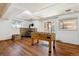Finished room features a stone fireplace, a foosball table, hardwood floors, and access to the outdoors at 7904 Hill Crest Dr, Louviers, CO 80131