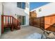 Backyard patio area with stairs, a privacy fence, and some patio furniture at 1315 Estes St # 13C, Denver, CO 80215