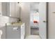 Well-lit bathroom with a vanity and a doorway leading into a bedroom at 1315 Estes St # 13C, Denver, CO 80215